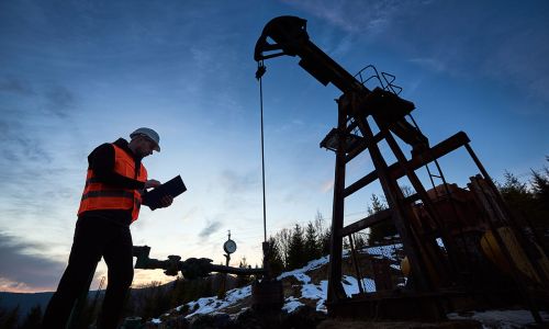 Oil Rig Worker Checking Drilling Machine